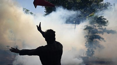Army personnel use tear gas to disperse demonstrators during an anti-government protest outside the office of Sri Lanka's prime minister in Colombo.