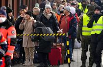 Displaced Ukrainians stand in a line on the train platform after arriving from Ukraine at the station in Przemysl, Poland, Thursday, March 3, 2022.