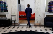 French President Emmanuel Macron exits a lobby in the presidential Elysee Palace, in Paris, on June 21, 2022,