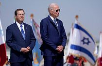 President Joe Biden stands with Israeli President Isaac Herzog, left, after arriving at Ben Gurion Airport, Wednesday, July 13, 2022, in Tel Aviv.