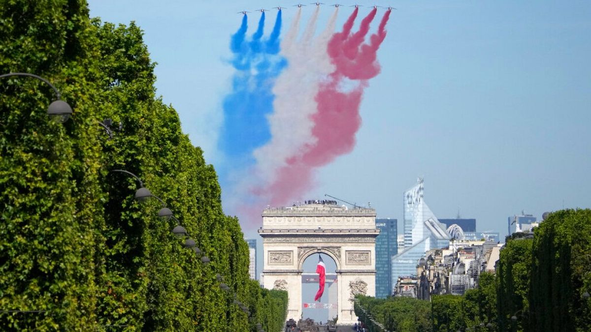 Alphajets of the Patrouille de France fly over the Champs-Elysees avenue during the Bastille Day parade Thursday, July 14, 2022 in Paris.