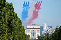 Alphajets of the Patrouille de France fly over the Champs-Elysees avenue during the Bastille Day parade Thursday, July 14, 2022 in Paris.