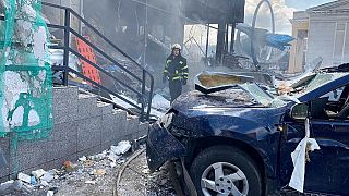 A Ukrainian firefighter stands among the damage after shelling in Vinnytsia, Ukraine, Thursday, July 14, 2022.