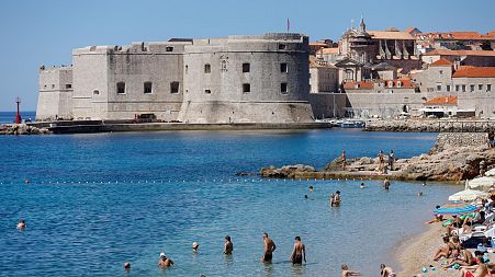 People enjoy Banje beach in Dubrovnik. Croatia is about to join the Eurozone.