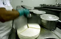 An employee works at a feta factory in Erythres, near Athens.