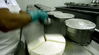 An employee works at a feta factory in Erythres, near Athens.