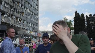 Ukrainian Interior Minister Denys Monastyrsky, right, reacts at a scene of damaged by shelling building in Vinnytsia