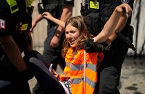 Police officers carry away climate activist Lina Schinkoethe during a protest with the group Uprising of the Last Generation at the chancellery in Berlin, Germany,.