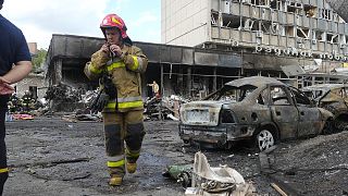A firefighter walks at the scene of a building that was damaged by a deadly Russian missile attack in Vinnytsia, 14 July 2022