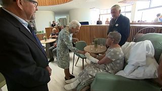 Queen meeting patient and medical staff.