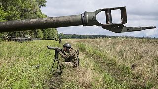 A Ukrainian serviceman prepares to fire at Russian positions from a US-supplied M777 howitzer in Kharkiv region, 14 July 2022