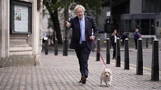 Britain's Prime Minister Boris Johnson arrives with his dog Dilyn to vote at a polling station in London on 5 May 2022