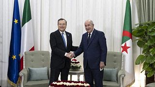 Italian Prime Minster Mario Draghi (L) shakes hands with Algerian President Abdelmadjid Tebboune (R) during their meeting in the capital Algiers on April 11 2022