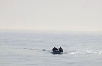 FILE - A group of people thought to be migrants arrive in an inflatable boat at Kingsdown beach after crossing the English Channel, near Dover, Kent, England, 2020. 