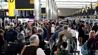 Passengers queue inside the departures terminal of Terminal 2 at Heathrow Airport in London, Britain, June 27, 2022. 