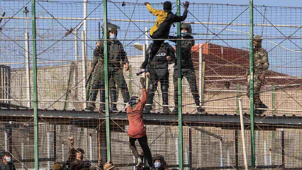 يتسلق المهاجرون السياج الفاصل بين جيب مليلية الإسباني والمغرب، الجمعة 24 يونيو 2022