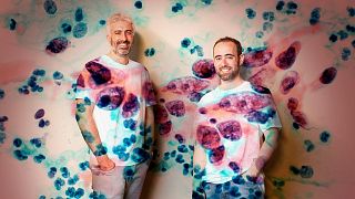 Owkin's co-founders Thomas Clozel MD, CEO, and Gilles Wainrib, Chief Scientific Officer, overlaid with a digital slide image of a cervical cancer tumour.