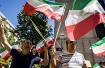 Iranian opposition supporters protest outside the US embassy during a NATO summit in Brussels.