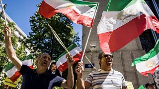 Iranian opposition supporters protest outside the US embassy during a NATO summit in Brussels.