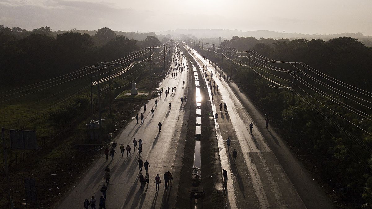 Viajeros caminan a lo largo de la Carretera Panamericana debido a los bloqueos establecidos por los manifestantes que se manifiestan contra la inflación