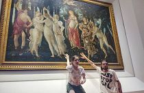 Two activists of Ultima Generazione environmentalist group claim to glue themselves to the glass protecting Botticelli's masterpiece in Florence, 22 July 2022