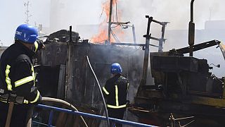Ukrainian firefighters battling fire on a boat burning in the port of Odessa after Russian missiles hit, 23 July, 2022.