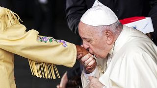 Pope Francis kisses the hand of residential school survivor Elder Alma Desjarlais of the Frog Lake First Nation as he arrives in Edmonton, Canada, on Sunday, July 24, 2022.