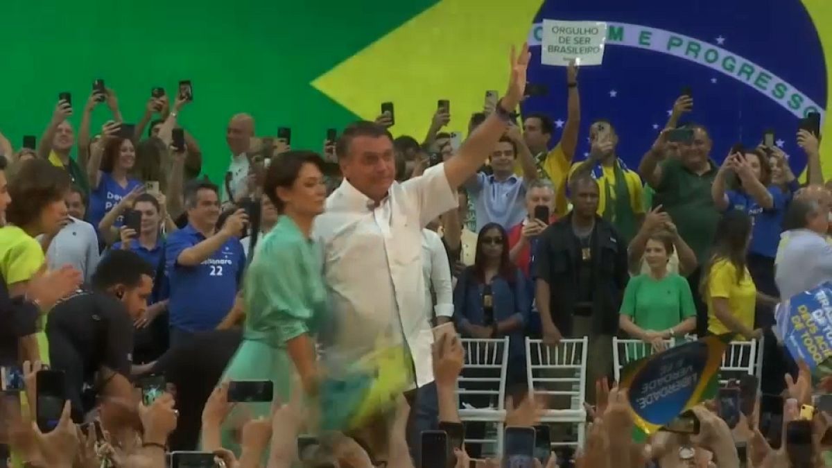 Jair Bolsonaro greets supporters at a rally in Rio
