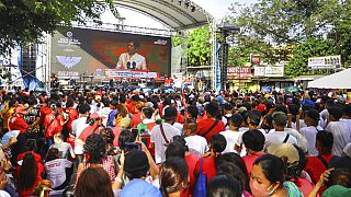 Supporters of new President Ferdinand Marcos Jr. watch the state of nation speech in a big screen