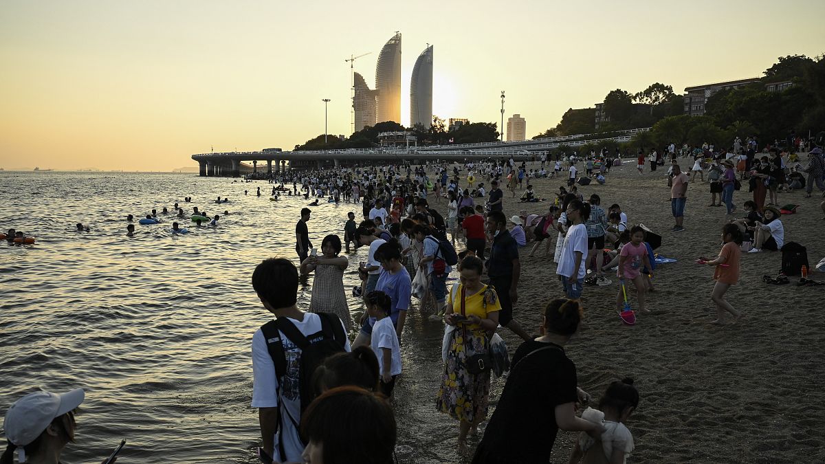 People gather at Baicheng beach in Xiamen.