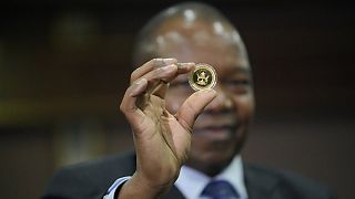To stem inflation, Zimbabwe debuts gold coins as legal tender