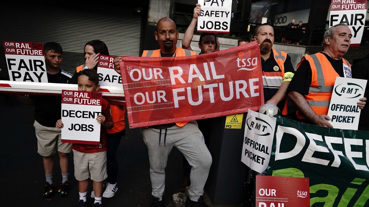 Members of the TSSA and RMT unions and their families on the picket line outside London Euston train station on July 27, 2022.