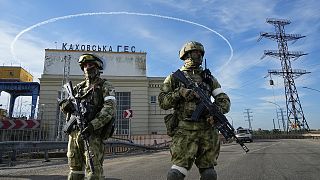 Russian troops guard an entrance of the Kakhovka Hydroelectric Station, a run-of-river power plant on the Dnieper River in Kherson region, 20 May 2022
