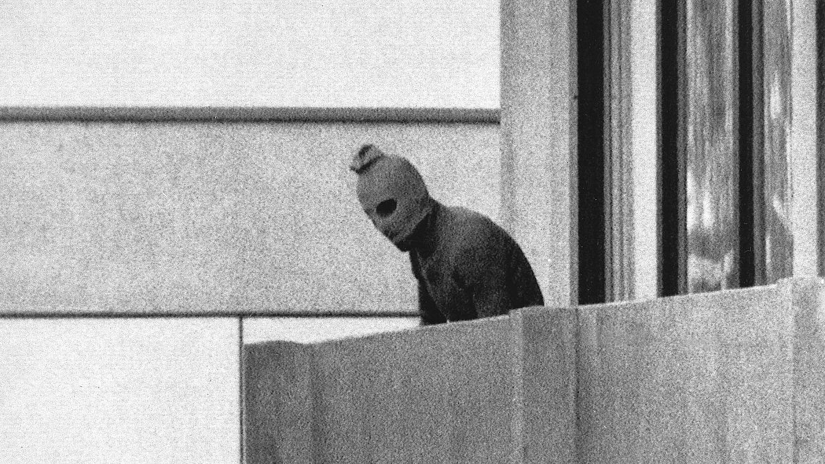 A member of the Arab Commando group which seized members of the Israeli Olympic Team stands on the balcony where they held them hostage in Munich, 5 September 1972.