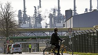 A worker rides his bicycle to the BP oil refinery Ruhr Oil in Gelsenkirchen, Germany, Monday, March 28, 2022.