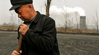 Egy férfi dolgozik a kínai Tajüan gyárától nem messze 2007-ben - Kína 2006 óta a világ legnagyobb szén-dioxid kibocsátója