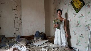 Daria Steniukova, 31, yoga coach poses for a picture during the wedding photo shooting in her bombed flat in Vinnytsya on July 16, 2022.