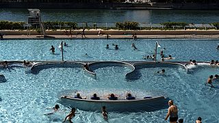 People cool off in a swimming pool in Lyon, France