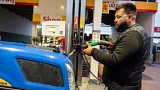 Farmer Dimitris Kakalis, 25, fills his tractor with diesel at a gas station, in Tyrnavos town, central Greece, Sunday, Feb. 13, 2022.