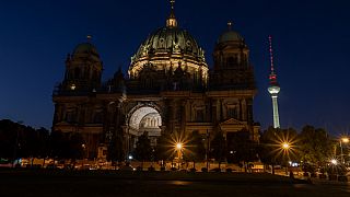 The Berlin Cathedral is no longer fully illuminated in Berlin, Germany as part of an energy-saving measure, Wednesday, July 27, 2022. (Paul Zinken/dpa via AP)