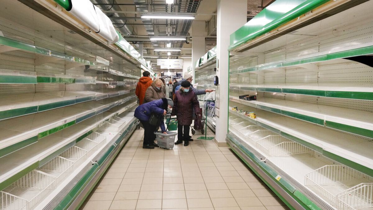 People buy the last remaining groceries at a Finnish PRISMA store as they know the store will close soon, in St. Petersburg, Russia, Tuesday, March 15, 2022. 