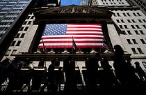 People walk past the New York Stock Exchange on Wednesday, June 29, 2022 in New York.