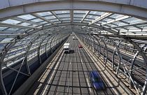 Cars drive through a soundproof tunnel covering a highway in Warsaw, Poland, 