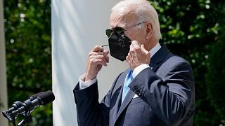 President Joe Biden removes his face mask as he arrives to speak in the Rose Garden of the White House in Washington, Wednesday, July 27, 2022. 