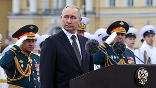 Russian President Vladimir Putin, center, delivers his speech prior to the military parade during Navy Day celebrations on the Neva River, St.Petersburg, 22 July 2022