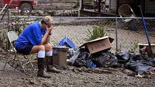 تجلس تيريزا رينولدز منهكة بينما يقوم جيرانها بإزالة الحطام من منازلهم التي دمرتها الفيضانات في ولاية كنتاكي، الولايات المتحدة، السبت 30 يوليو 2022
