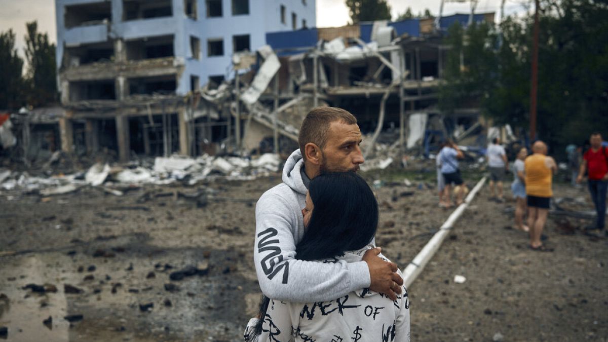 A couple reacts after the Russian shelling in Mykolaiv, Ukraine, Wednesday, Aug. 3, 2022.