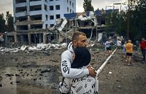 A couple reacts after the Russian shelling in Mykolaiv, Ukraine, Wednesday, Aug. 3, 2022.