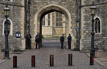 Police guard the Henry VIII gate to Windsor Castle in Windsor, 16 February 2022
