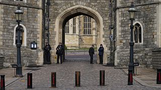 Police guard the Henry VIII gate to Windsor Castle in Windsor, 16 February 2022